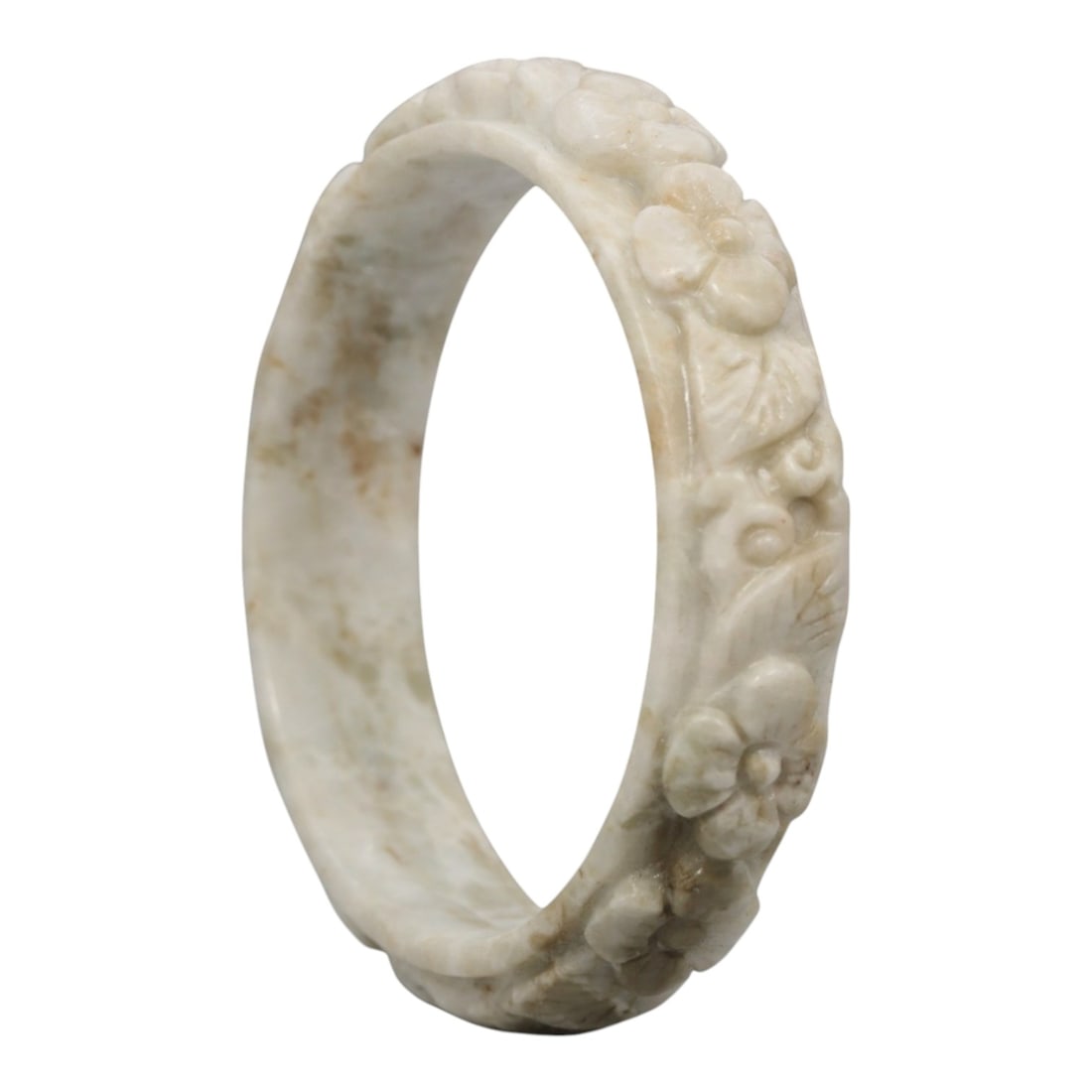 A Chinese Carved Jadeite Jade Bangle Bracelet, 20th Century, 29ZL: A fine jadeite bangle of flattened circular form, masterfully carved in relief with a continuous band of floral blossoms and scrolling foliate motifs. The stone exhibits a creamy white base, accented 