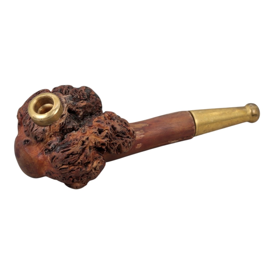 A Carved Wood Smoking Pipe, 20th Century, 23FH: Carved from hardwood, the pipe is composed of a compact bowl with a cylindrical interior and a tapered stem fitted with metal mounts. The bowl exterior is worked in high relief to follow the natural b