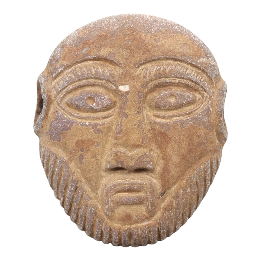 A Near Eastern Stone Maskette, 1st Millennium BCE, 29FL: Carved from brownish-tan stone with natural surface patination and minor chipping, the maskette is shaped as a rounded face with prominent, stylized features. The eyes are large and almond-shaped, eac