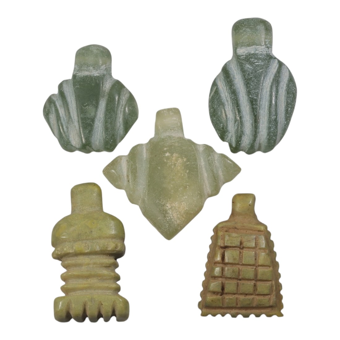 Lot of 4 Ancient Coptic Egyptian Green Stone Amulets, Circa Roman to Coptic Era, 48AE: The group comprises four carved stone amulets of varying forms, including zoomorphic and geometric shapes associated with Egyptian religious iconography. Three examples are carved from translucent gre
