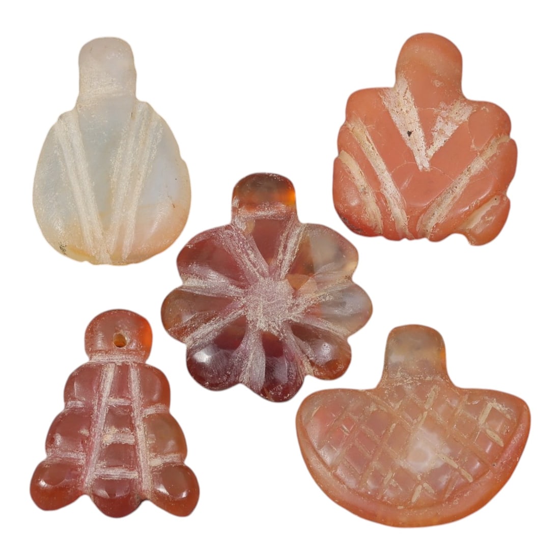 Lot of 5 Ancient Coptic Egyptian Carnelian Amulets, Circa Roman Period to Coptic Era, 80AD: Comprising five carved carnelian amulets, each approximately 2 cm in height, these pieces reflect the rich symbolic traditions of Coptic Egyptian jewelry. Each amulet is expertly shaped from warm-tone