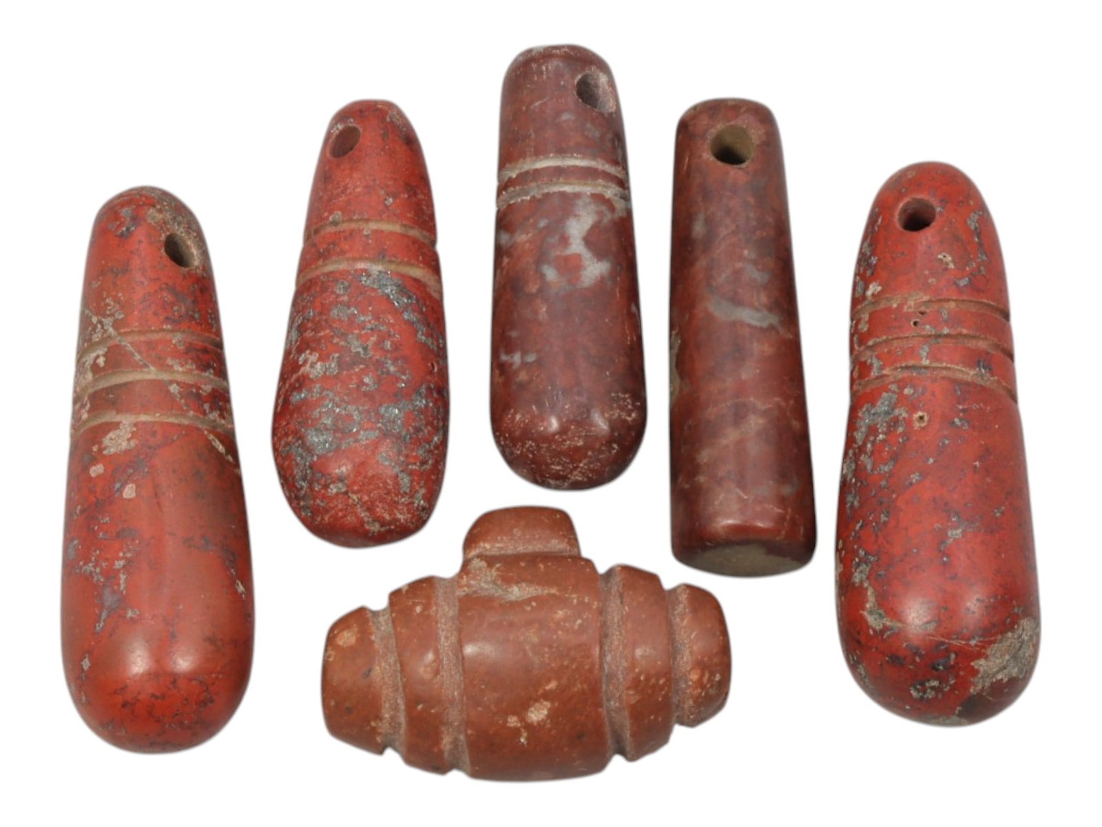 Lot of 6 Ancient Coptic Egyptian Red Stone Amulets, Circa Roman to Coptic Era, 69WT: Carved from rich red stone with natural veining and surface patina, the group consists of six distinct amulets, ranging in size from 2.3 cm to 3.5 cm (0.91-1.38 in.). The set includes five elongated, 