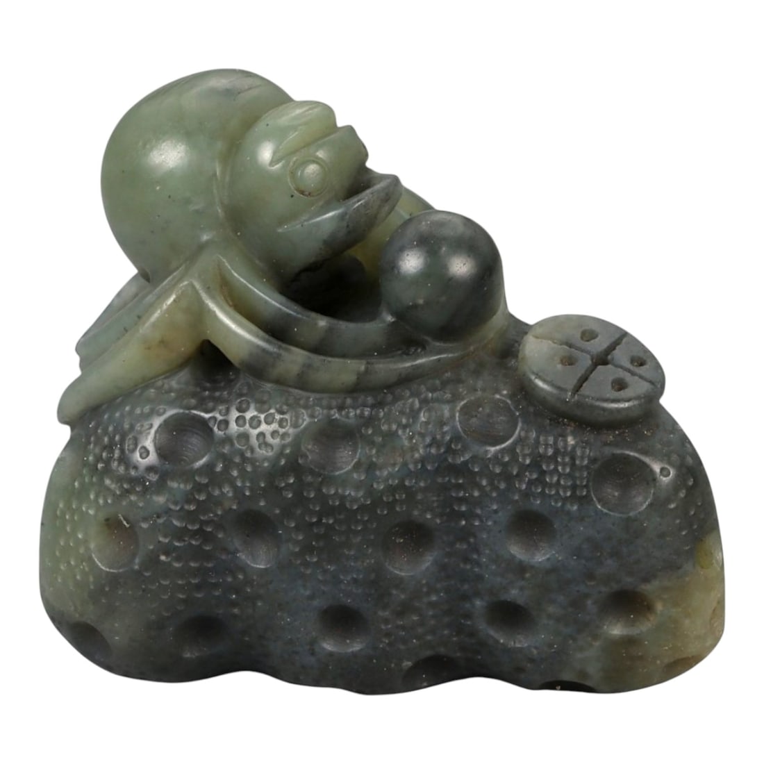 A Chinese Nephrite Jade Spider Carving, 20th Century, 78FB: Carved from dark green nephrite jade with mottled inclusions and areas of lighter translucency, the object is modeled as a spider resting upon a textured ground. The body is carved in the round, with 