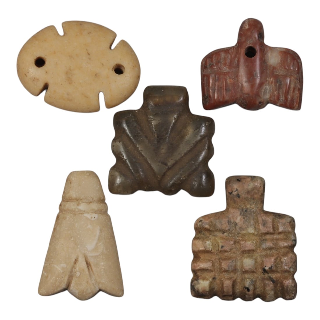 Lot of 5 Ancient Coptic Egyptian Stone Amulets, Circa Roman to Coptic Era, 95WP: Carved from various stones, including light beige, greyish-brown, reddish-brown, and mottled pinkish varieties, the group consists of five distinct amulets. The set includes a flat oval pendant with t