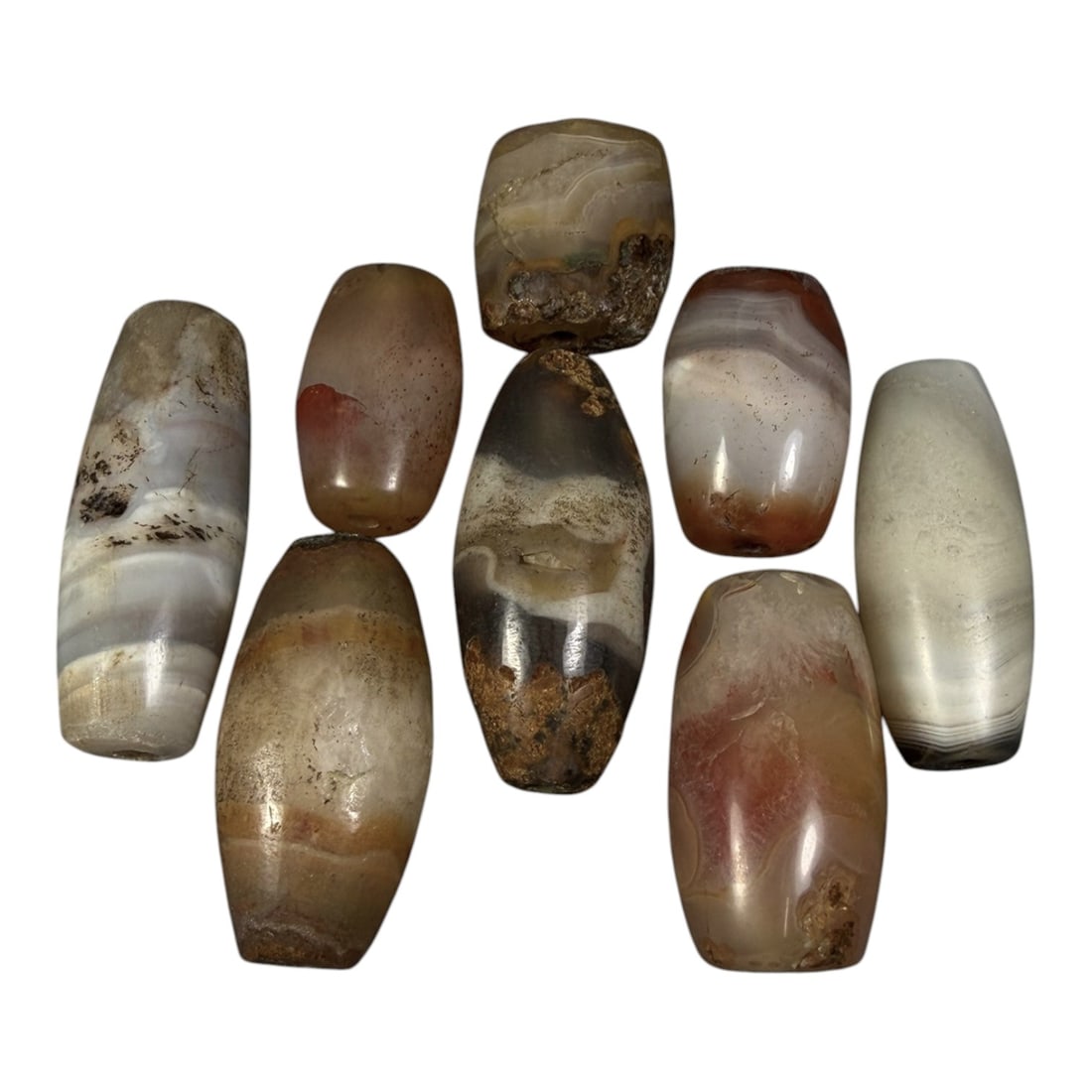 Lot of 8 Himalayan Banded Agate Beads, Ancient to Antique Period, 96AG: A group of eight beads crafted from banded agate, exhibiting natural tonal variations including translucent grey, white, reddish-brown, and earthy beige hues, with characteristic concentric, linear, a
