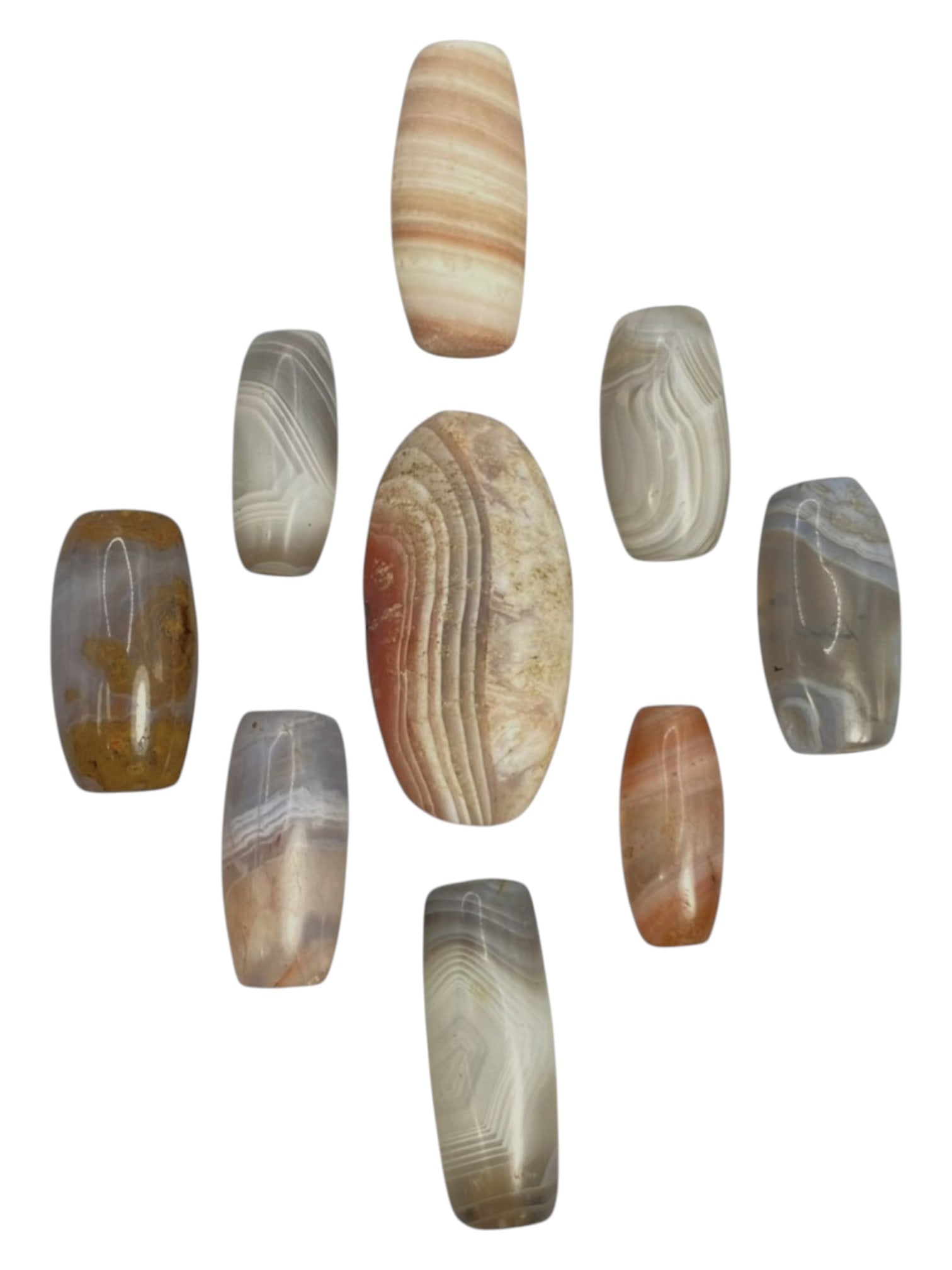 Lot of 9 Himalayan Banded Agate Beads, Ancient to Antique Period, 44WT: A group of nine beads crafted from banded agate, showcasing natural hues including translucent grey, milky white, peach, and amber tones, with characteristic concentric, wavy, and linear banding patte