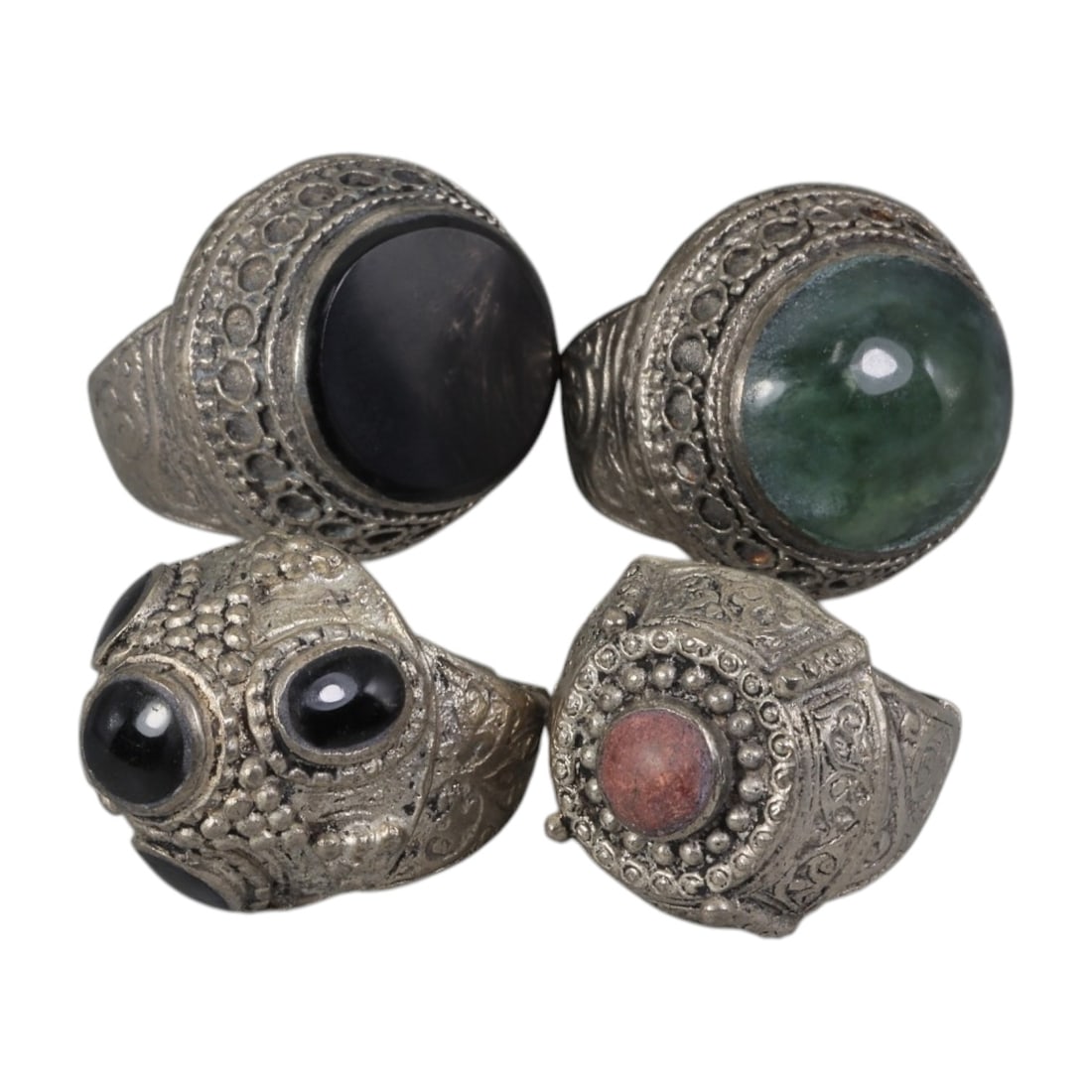 Lot of 4 Vintage Central Asian Tribal Silver-Plated Statement Rings, 7AH: A set of four vintage statement rings, crafted in silver-plated metal with intricate tribal-style ornamentation characteristic of Central Asian or Himalayan jewelry traditions. Each ring features dist