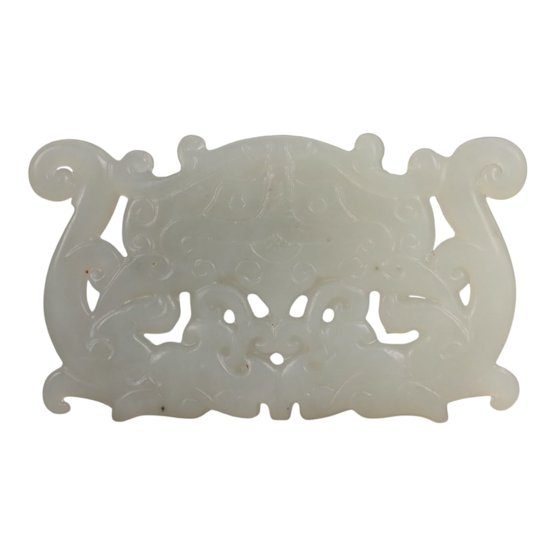 A Chinese Hetian Nephrite Jade Openwork Plaque, 20th Century, 67FD: Carved from pale celadon Hetian nephrite jade with even translucency and minor natural inclusions. The plaque is horizontally oriented and worked in openwork and low relief, with a symmetrical composi
