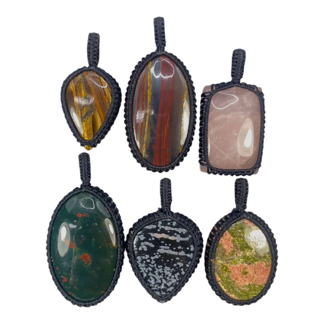 A Lot of 6 Macrame-Wrapped Gemstone Pendants, 11WS: This lot includes six handcrafted macrame-wrapped gemstone pendants, each measuring 5-7 cm in height. The collection features a diverse array of natural stones, including tiger's eye, banded ironstone