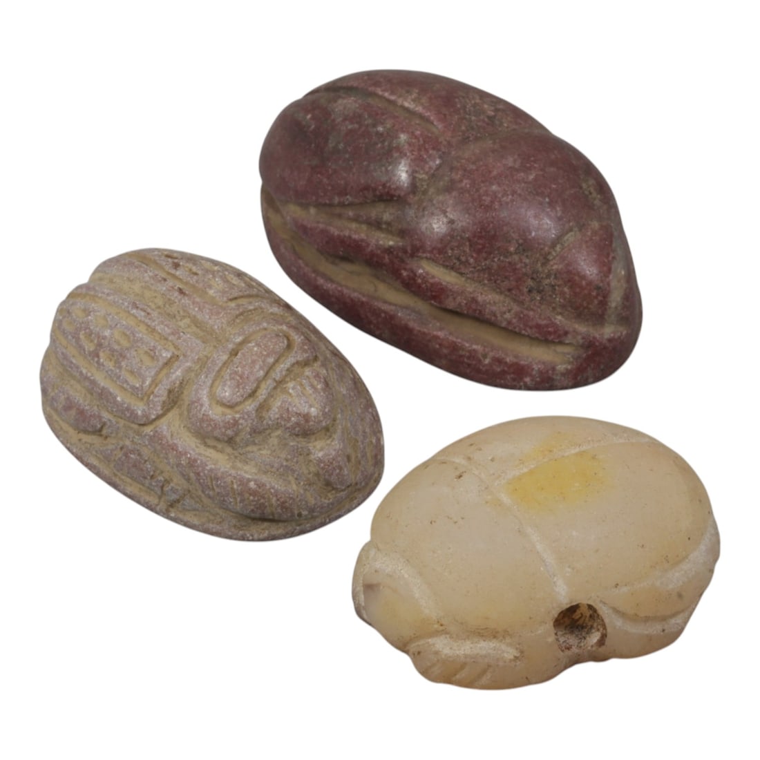 Lot of 3 Ancient Coptic Egyptian Multi-Stone Scarabs, Circa Roman to Coptic Era, 99WT: Carved from various stones, including reddish-brown, weathered pinkish, and light translucent varieties, the group consists of three distinct scarab amulets. Each piece features the characteristic sca