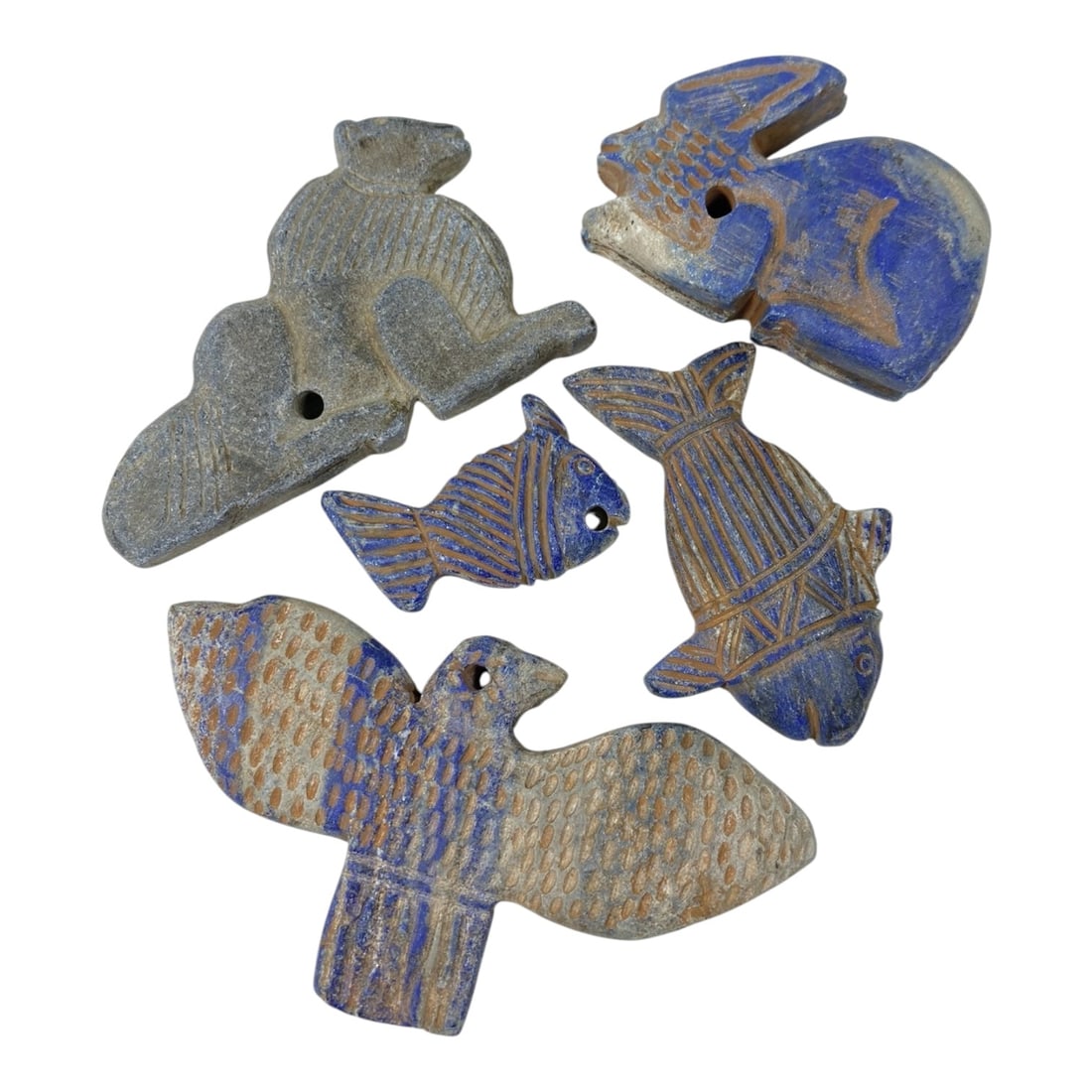 A Lot of 5 Ancient Lapis Lazuli Animal Amulets, 34AC: The group comprises five carved lapis lazuli amulets, exhibiting rich blue tones with natural mineral inclusions and earthy patina consistent with antiquity, featuring diverse animal forms including a