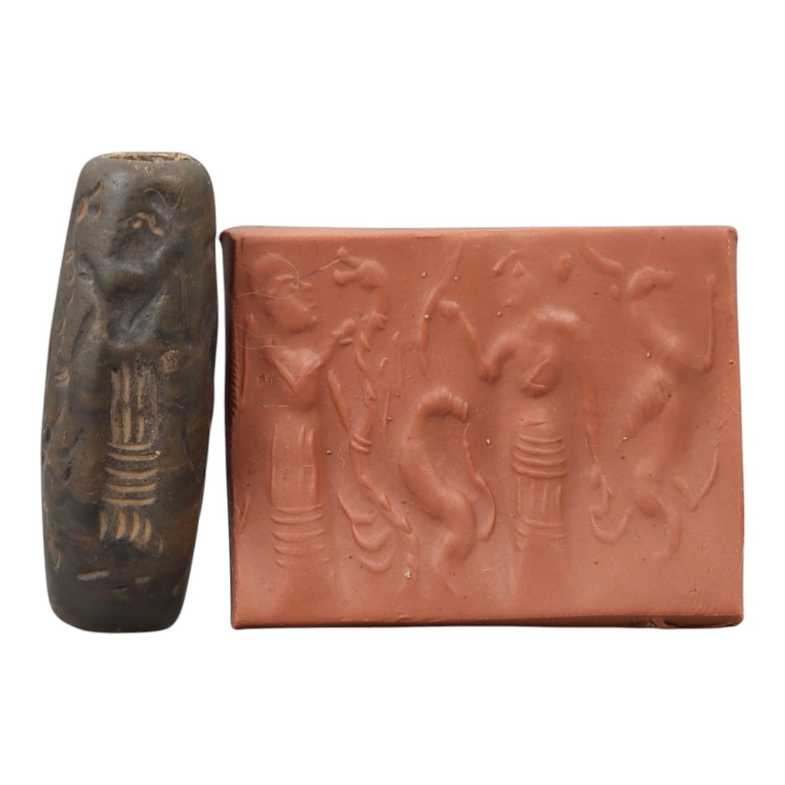 Ancient Steatite Cylinder Seal - Mesopotamian Figural & Animal Ritual Scene, 76AN: Carved from dense steatite, this ancient Mesopotamian cylinder seal features a detailed linear relief composition of two human figures interacting with animal and botanical motifs, executed in the cha