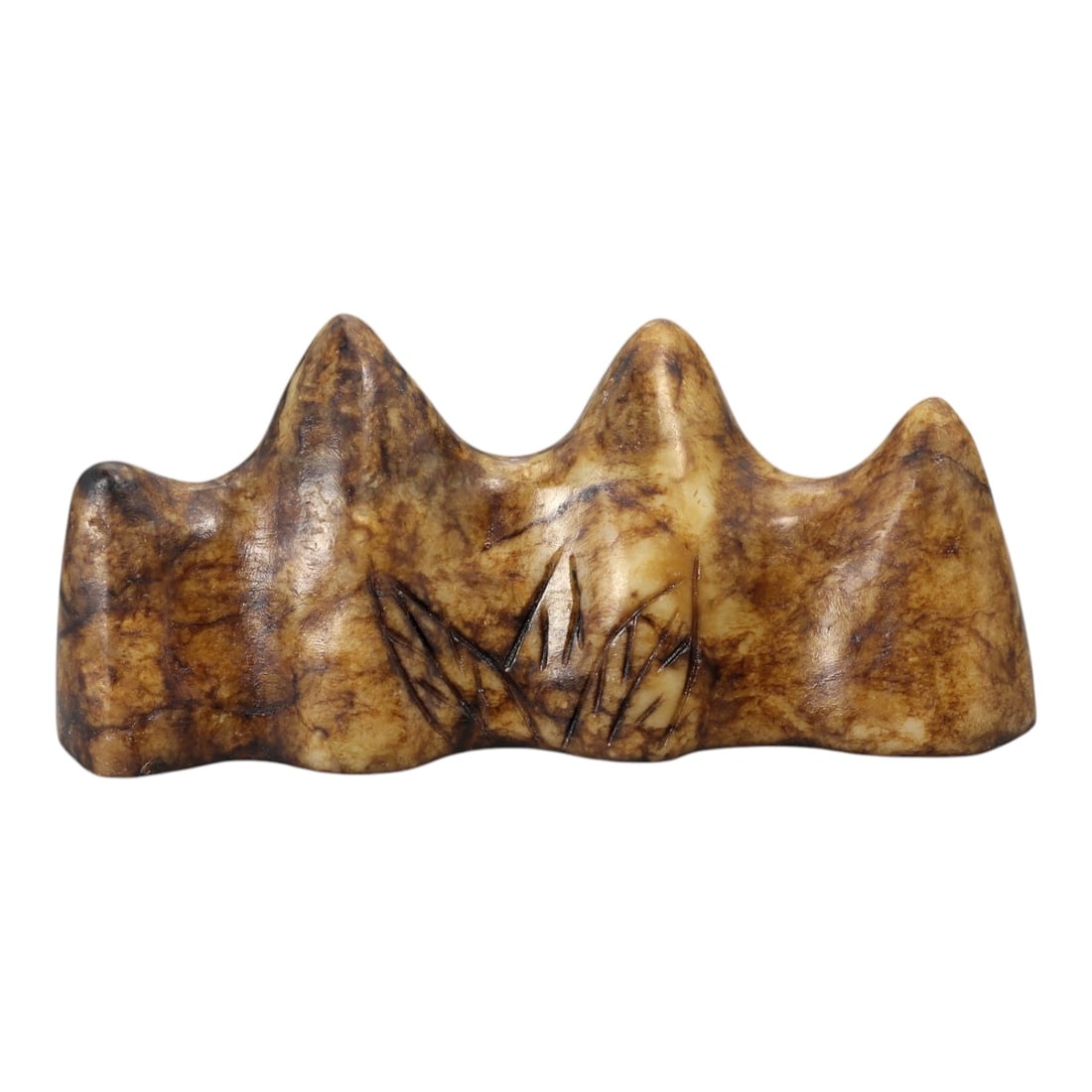 A Chinese Hardstone Brush Rest, 20th Century, 10YB: Carved from mottled brown and buff-toned hardstone with natural veining and tonal variation, the object is worked as a horizontal brush rest with an undulating upper profile formed by a series of roun
