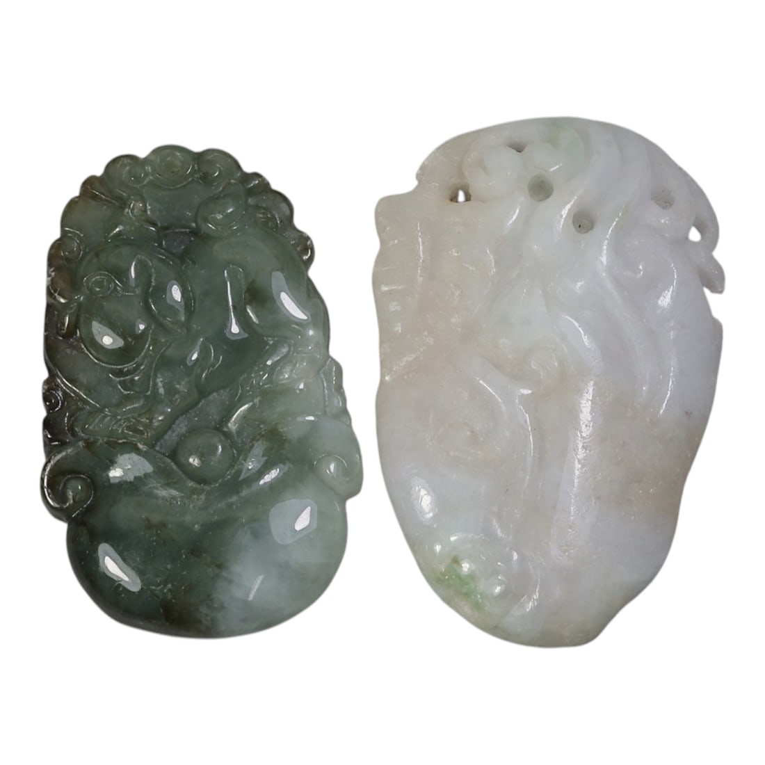 Lot of 2 Antique Oriental Chinese Jadeite Jade Carved Pendants, 50AG: Carved from jadeite jade with natural color variations, the two pendants feature traditional relief motifs. The left pendant, in varying shades of green with darker inclusions, depicts a stylized myth