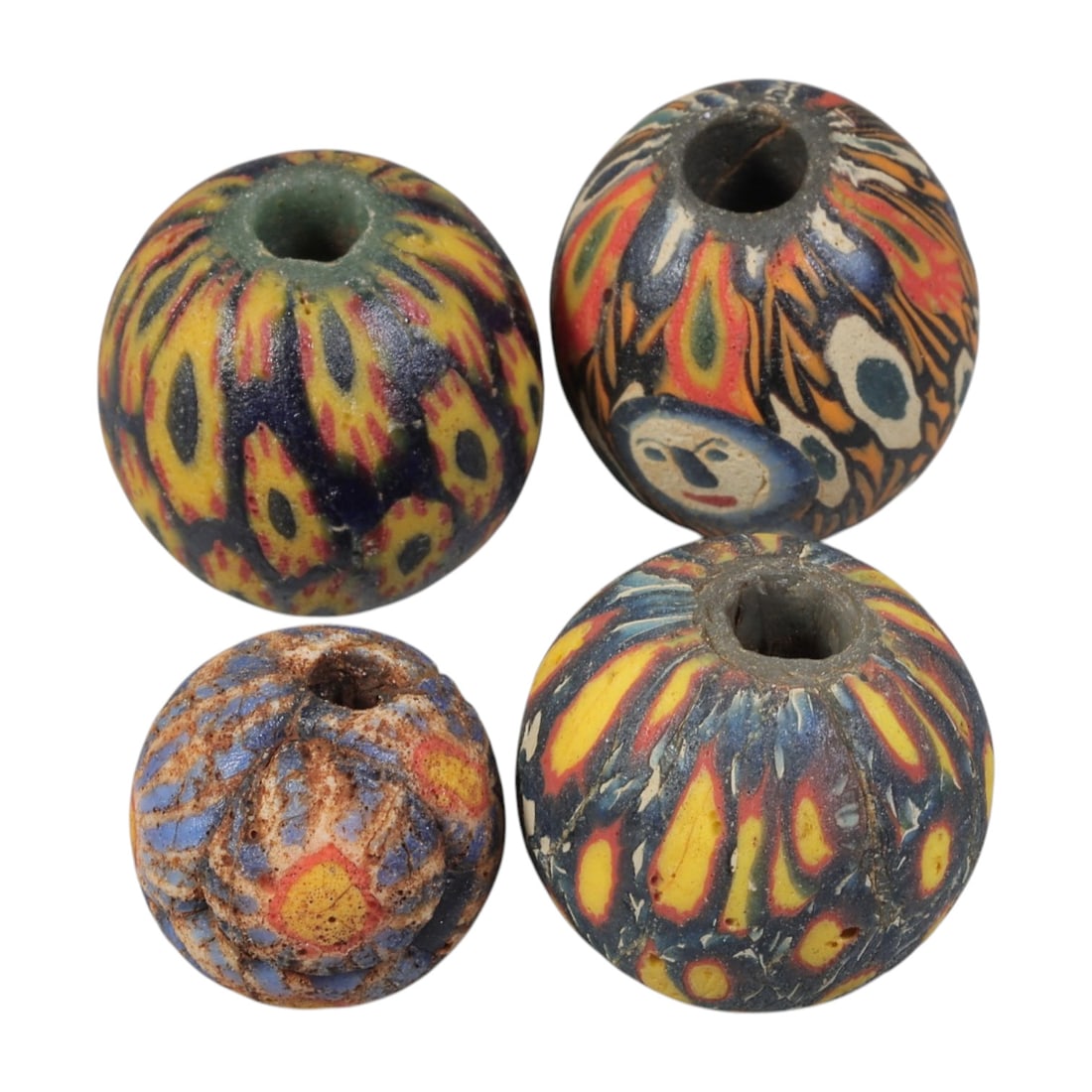 Lot of 4 Ancient to Antique Polychrome Glass Beads, 1st Mil BCE to Islamic Period, 31WM: A group of four spherical polychrome glass beads, each with a central perforation. The beads feature intricate mosaic and millefiori-style decoration, including eye motifs, flame patterns, and composi