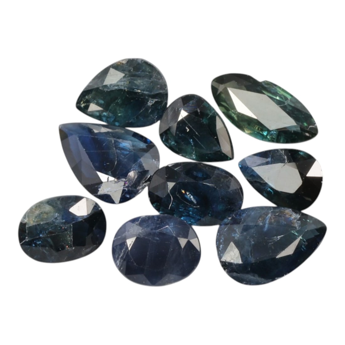 7.10 Carats Deep Blue Sapphire Parcel - Natural Mixed African Origin, 80XC: This curated parcel of loose sapphires showcases a rich spectrum of deep blue hues, ranging from velvety midnight blue and teal to subtle greenish-blue tones. The lot includes both pear and oval cuts,