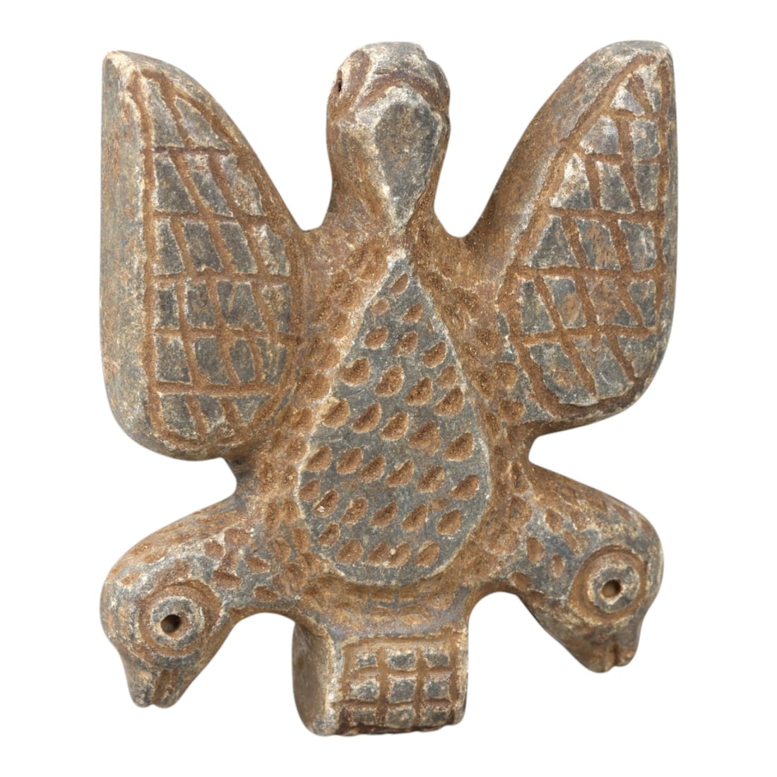 Ancient Stone Zoomorphic Amulet - Near Eastern Bird Figure, 21AM: This amulet is carved from dark stone, depicting a composite zoomorphic form with a central bird body, outstretched wings, and dual bird heads at the base, rendered in raised relief with incised geome