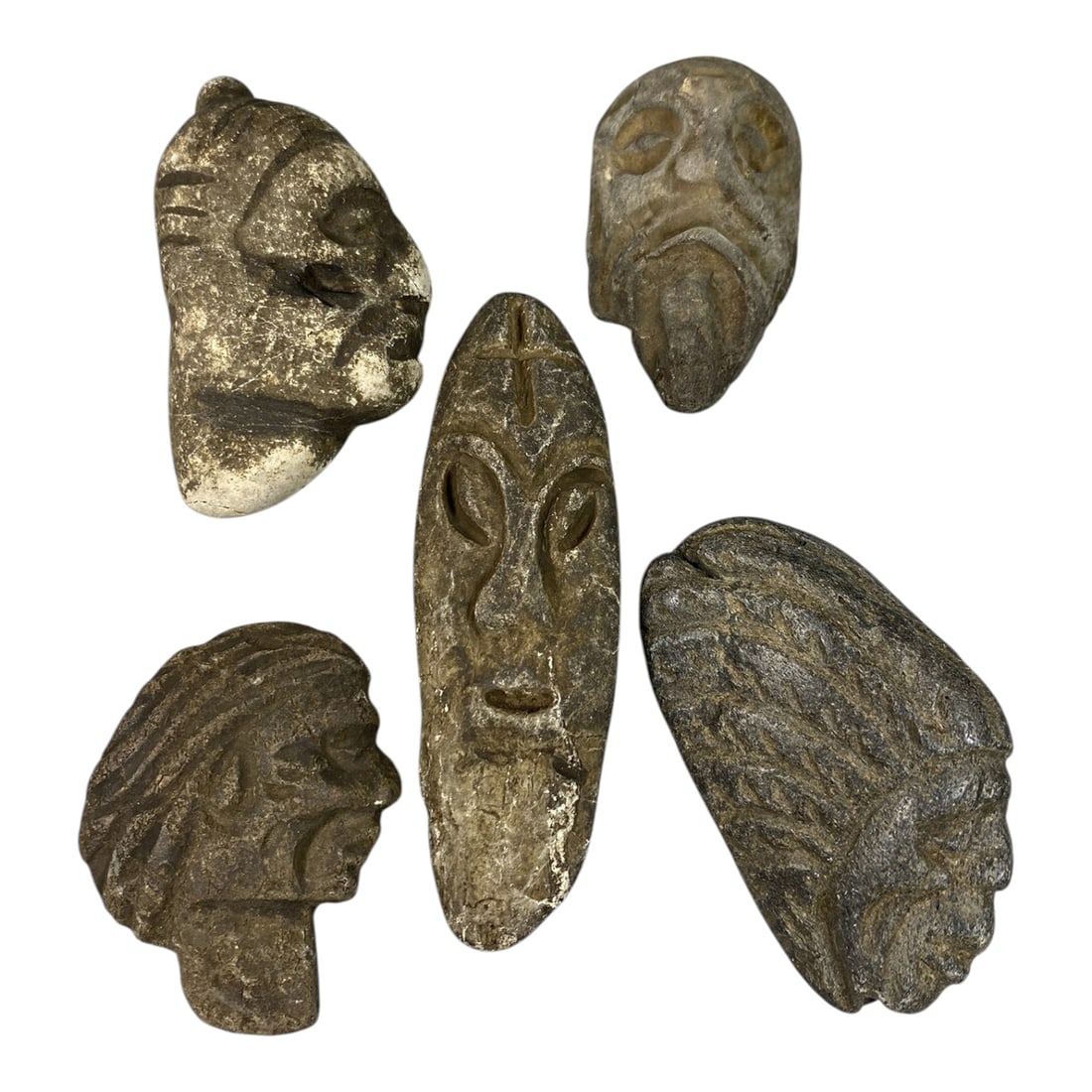 Lot of 5 Medieval Mediterranean Stone Head Carvings, 80AG: A collection of five hand-carved stone head carvings, attributed to medieval tribal or folk art traditions of the Mediterranean region. Crafted from weathered stone in varying earthy tones, the pieces