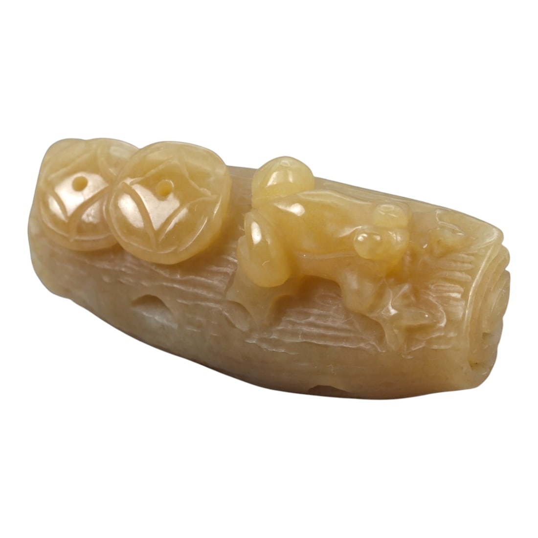 A Chinese Jade Frog and Coin Branch Ornament, 20th Century, 96FA: Carved from pale yellow jade with areas of soft translucency and natural tonal variation, the ornament is worked in the round as a frog and coin group resting on a stylized tree branch. The branch is 