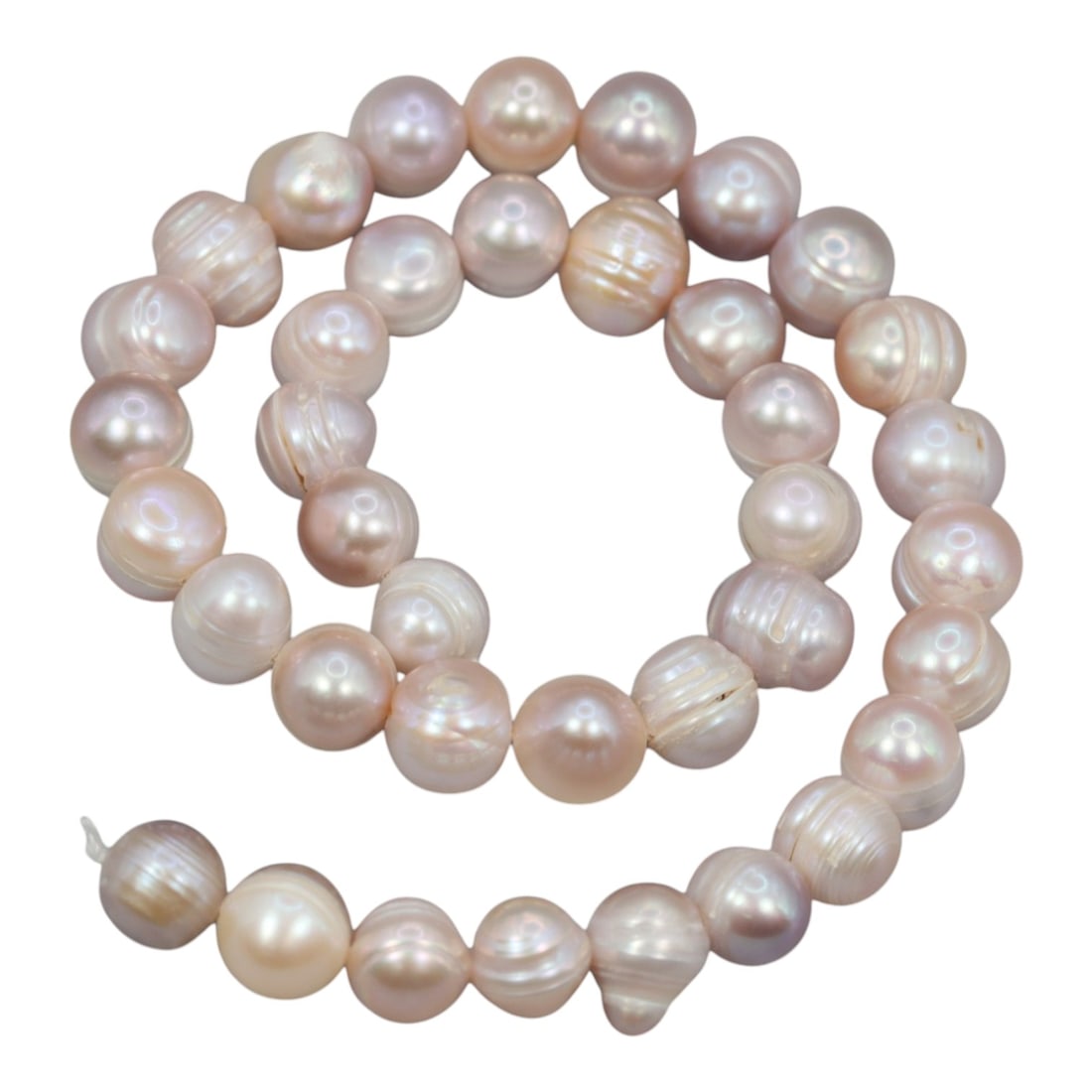 A Strand of Cultured Pearls, 20th Century, 87ZJ: Composed of near-round cultured pearls with a soft peach-pink body color and subtle iridescent overtones, the strand is strung in a single continuous line. Each pearl exhibits a smooth, lustrous surfa