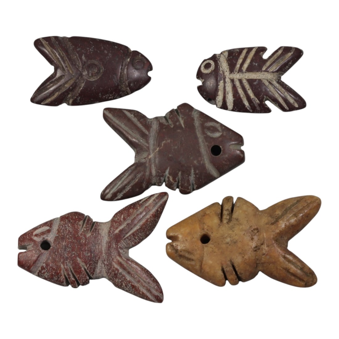 Lot of 5 Ancient Coptic Egyptian Stone Fish Amulets, Circa Roman to Coptic Era, 93WP: Carved from various stones, including dark reddish-brown and light tan varieties, the group consists of five flat fish-shaped amulets. Each piece features simplified incised detailing, including circu