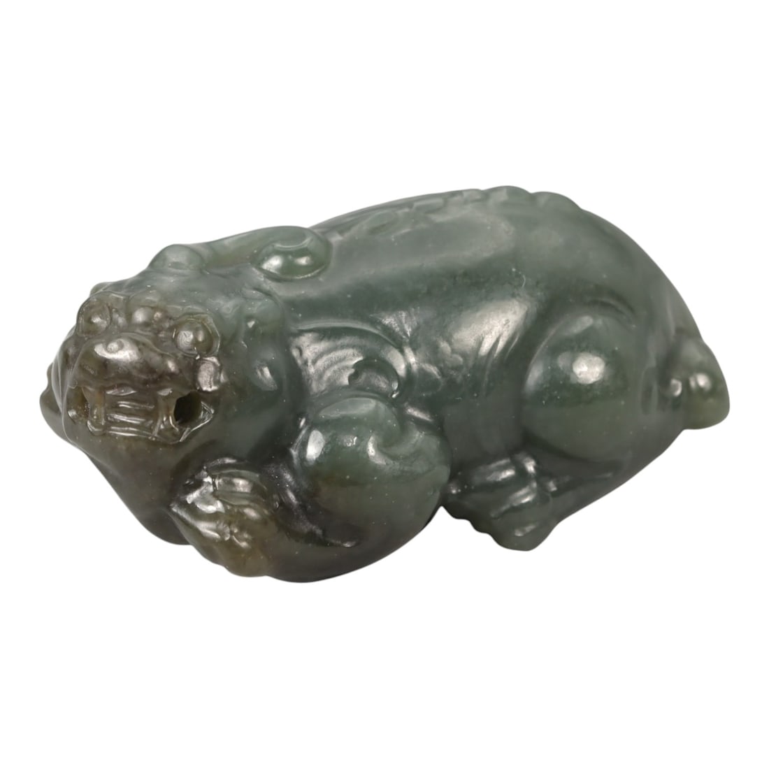 A Chinese Nephrite Jade Pixiu Figure, 20th Century, 65YA: Carved from green nephrite jade with areas of darker saturation and soft translucency, the figure represents pixiu, the mythical beast traditionally associated with protection and the attraction of we