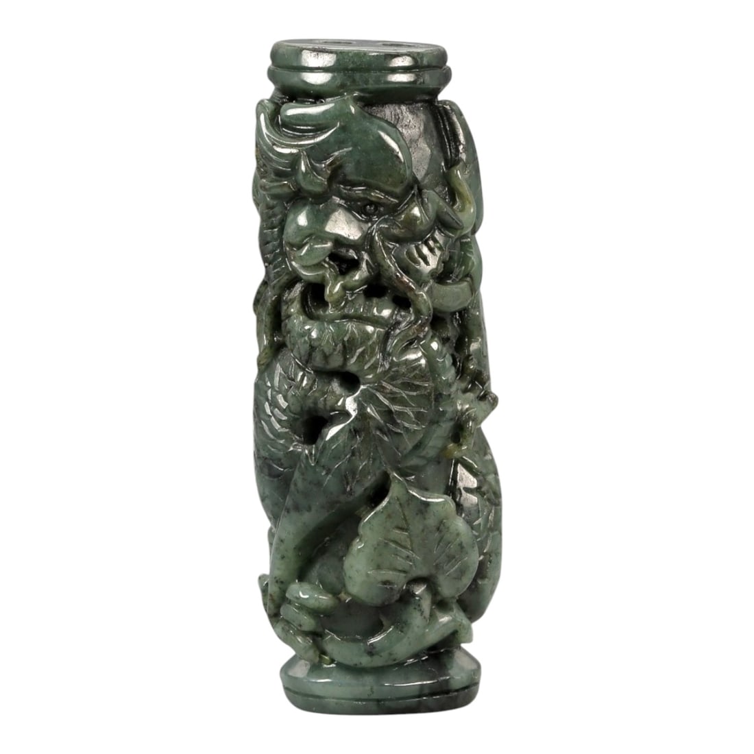 A Chinese Jadeite Carved Cylindrical Pendant, 20th Century, 67FB: Carved from dark green jadeite with lighter mottling and areas of natural translucency, the object is formed as a vertical cylindrical pendant with flat upper and lower terminals. The exterior is work