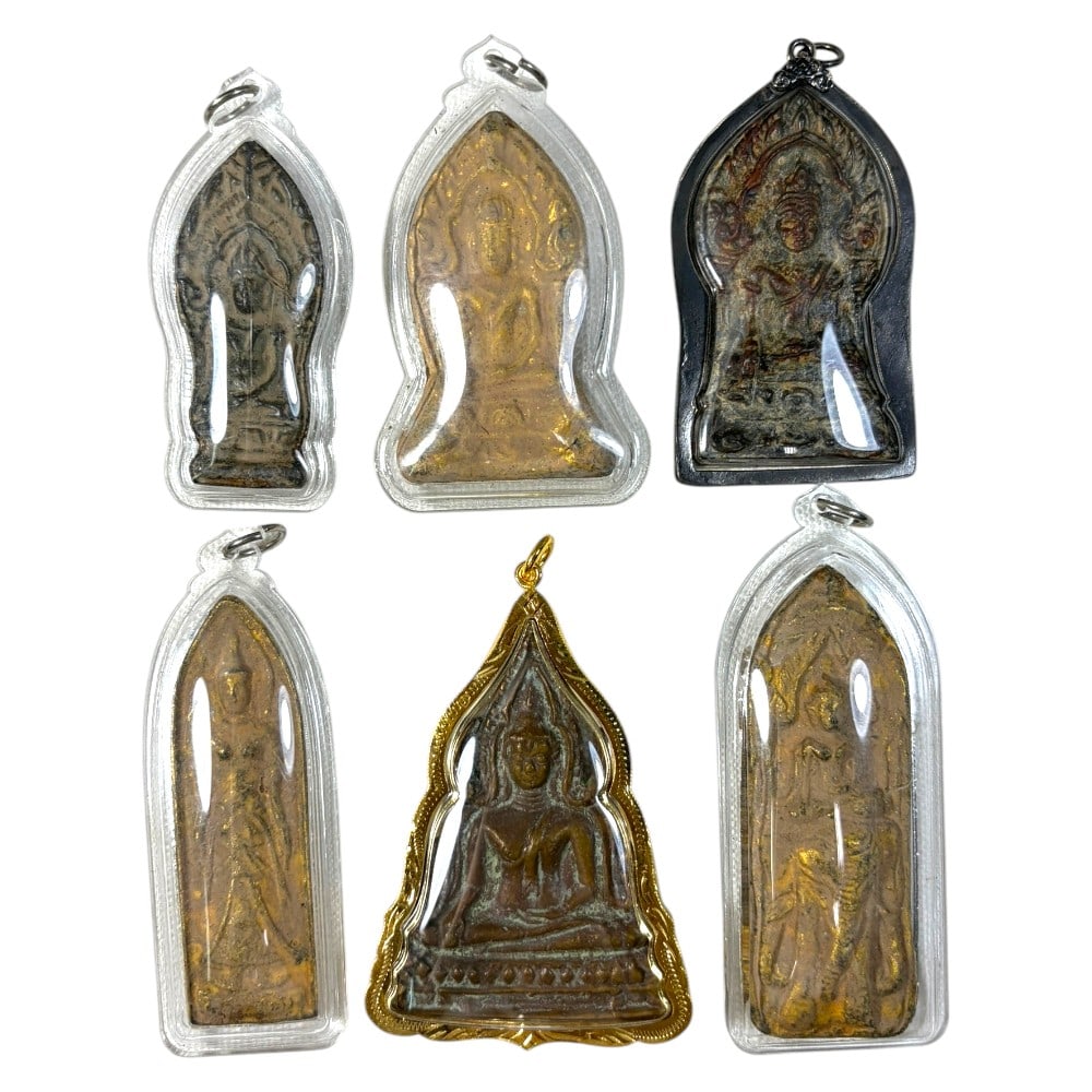 A Lot of 6 Vintage Thai Buddhist Amulets with Cases, 37AA: Comprising six pendants ranging from 7 to 9 cm in height. The group includes five amulets in clear protective plastic cases, and one seated Buddha amulet in an ornate gilt metal frame. The pieces feat