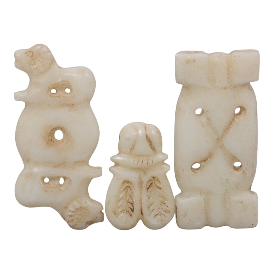 Lot of 3 Ancient Near Eastern Marble Amulets, c. Iron Age to Sasanian Period, 97WK: A set of three finely carved marble amulets from the Ancient Near East, featuring distinct symbolic motifs. The collection includes a zoomorphic quadruped pendant, a stylized scarab or insect form, an