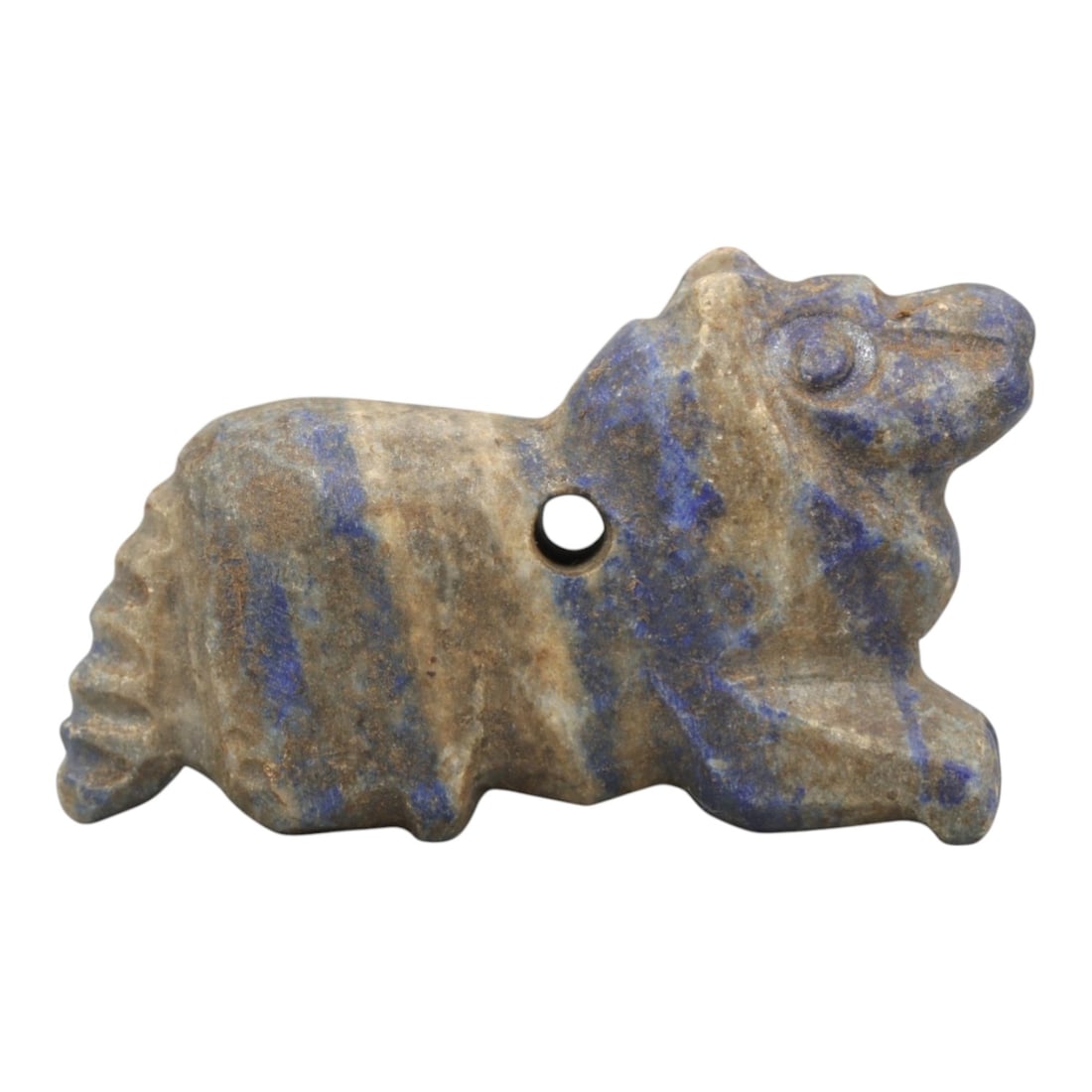 Ancient Lapis Lazuli Zoomorphic Amulet - Near Eastern Figurine, 25ZR: This artifact is a carved lapis lazuli zoomorphic amulet, executed in the stylized animal tradition of the ancient Near East. The amulet depicts a recumbent quadruped (likely a lion or canine) with si