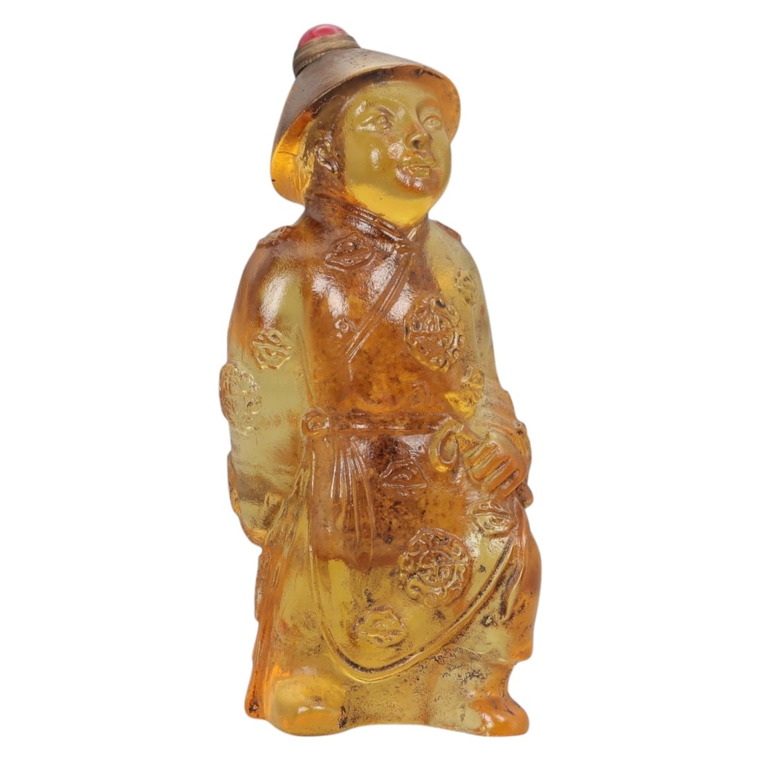 A Chinese Molded Glass Figural Snuff Bottle, 20th Century, 72FG: The snuff bottle is molded in the form of a standing male figure, likely representing a traditional attendant or official, dressed in long robes and a brimmed hat. The glass is of warm amber-golden to
