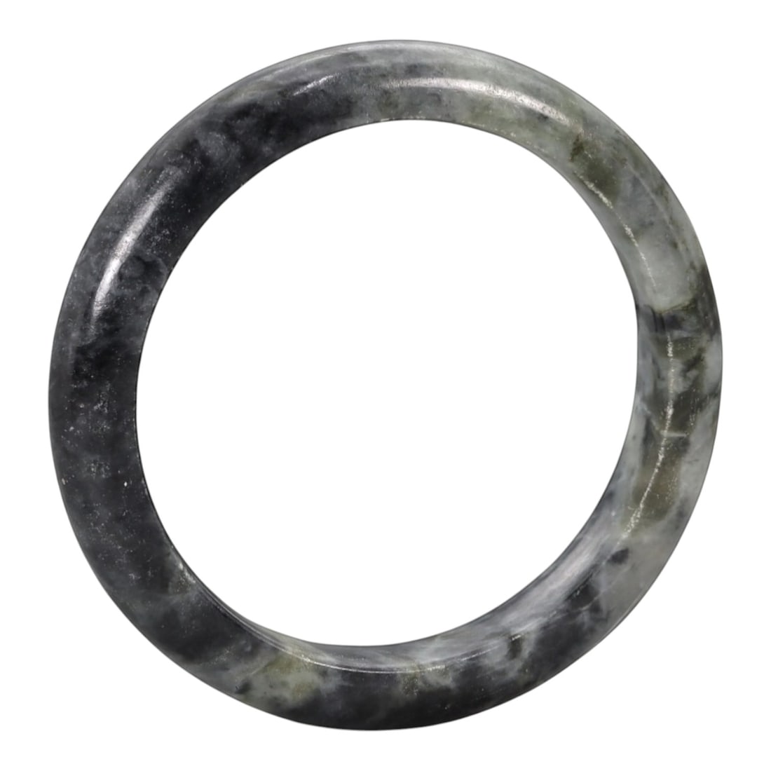 A Chinese Jadeite Jade Bangle Bracelet, 20th Century, 97ZK: Carved from jadeite jade with a deep greyish-black base and subtle pale grey marbling throughout, the bangle is formed as a solid, continuous circular band with a classic rounded cross-section. The su