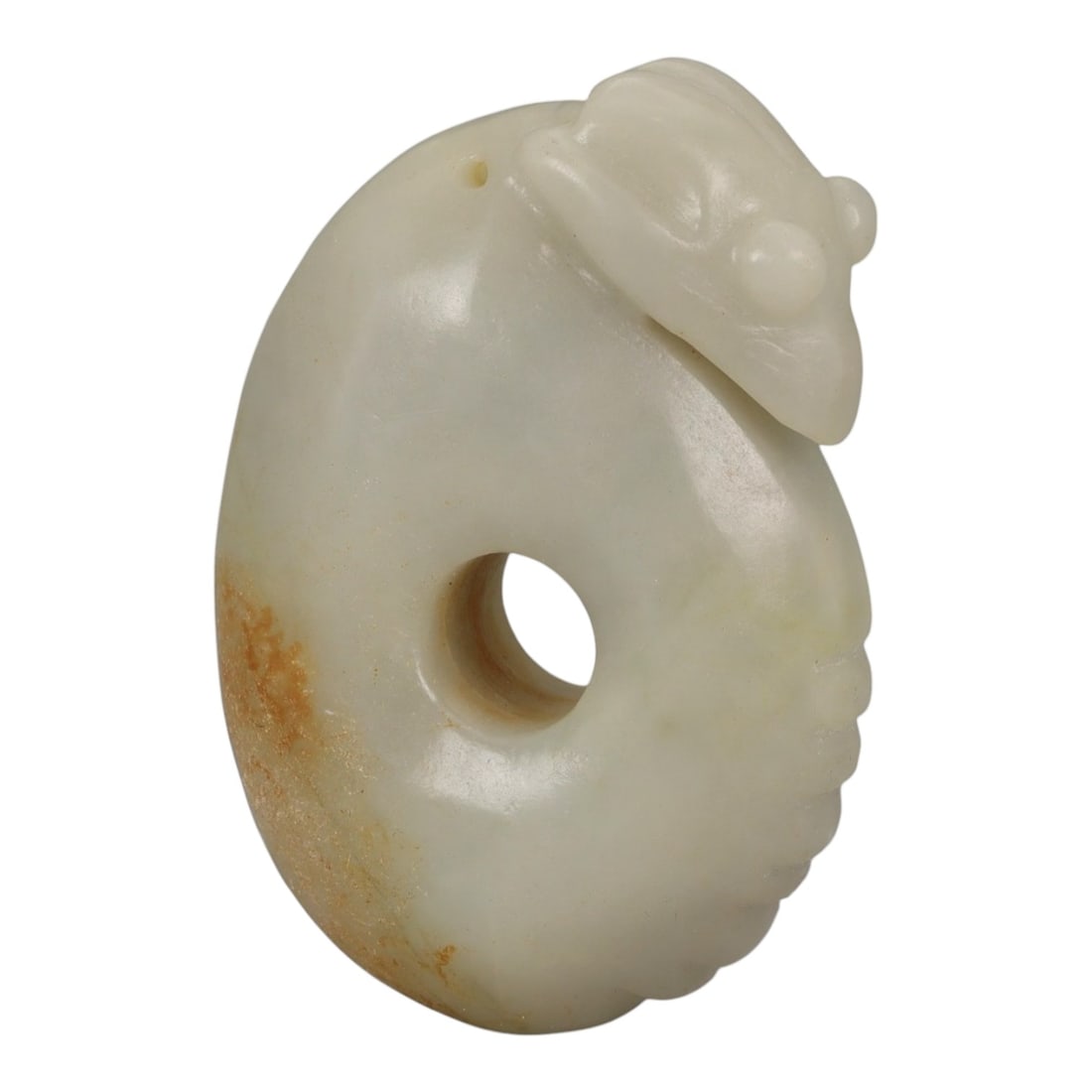A Chinese Hetian Jade Pendant, 20th Century, 56YB: Carved from pale creamy-white Hetian jade with areas of natural russet coloration, the pendant is worked as a thick oval form pierced by a circular central aperture. One side is carved in low relief w