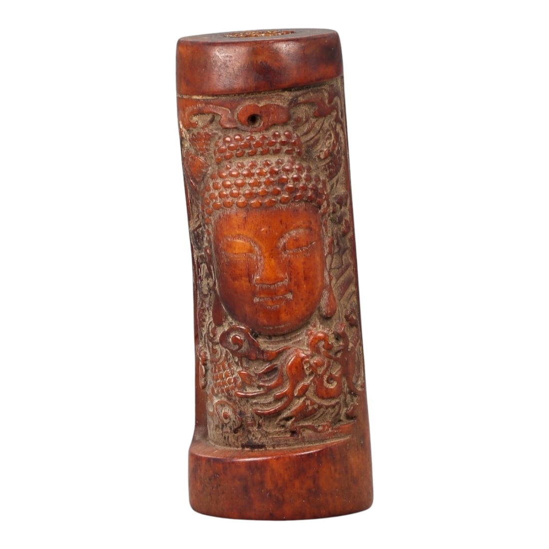 A Chinese Carved Bone Cylindrical Container with Buddhist Head and Dragon Motifs, 20th Century, 89FC: Carved from bone and worked in cylindrical form, the container is decorated in high relief with a serene Buddhist head, the face shown with downcast eyes, softly modeled features, and a beaded headdre