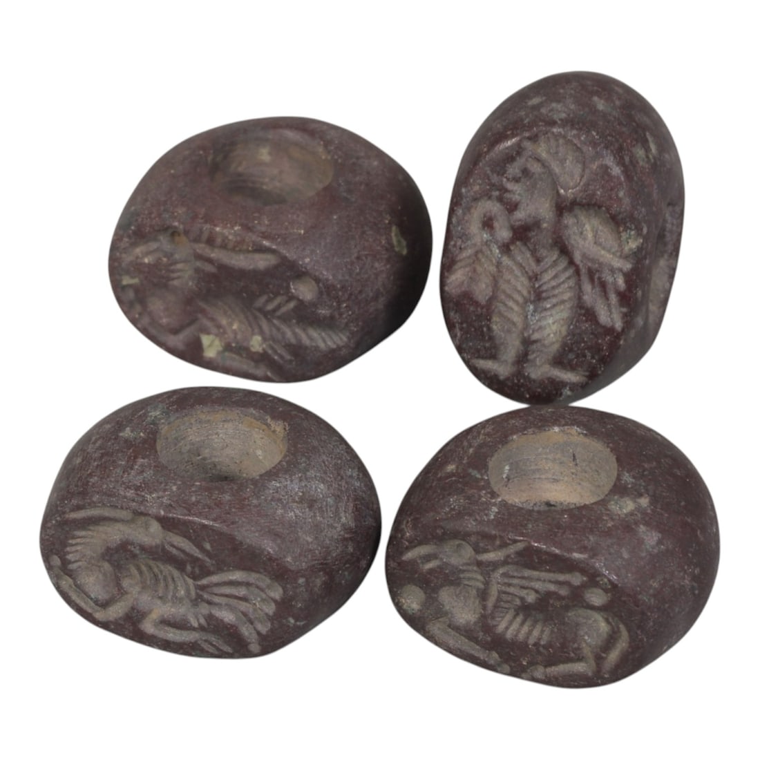 Lot of 4 Ancient Sasanian Jasper Stamp Seals, Circa 3rd-7th Century CE, 71WP: A collection of four Sasanian period stamp seals, carved from rich reddish-brown jasper stone, each featuring a central drilled hole for suspension. The seals display characteristic Sasanian iconograp