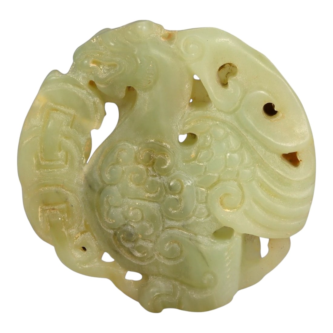 Chinese Jade Pendant - Openwork Mythical Animal Carving 4.7cm, 97ZD: Carved from pale celadon jade with warm honey and light russet inclusions, this circular pendant is worked in pierced openwork to depict a stylized mythical beast in profile. The creature's rounded he