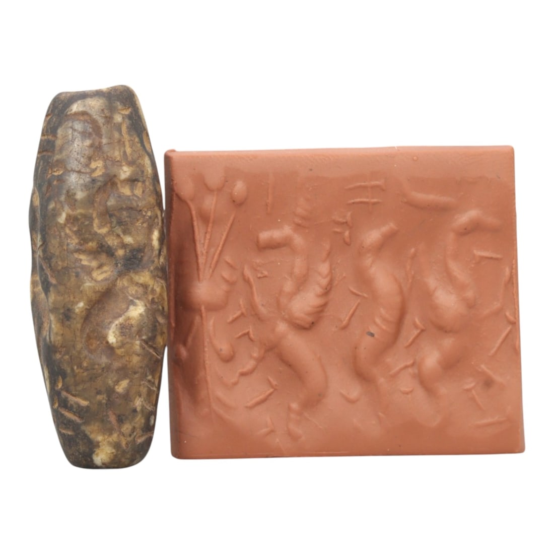 Ancient Steatite Cylinder Seal - Mesopotamian Mythological Carving, 82ZR: Crafted from dense steatite, this ancient Mesopotamian cylinder seal displays precise hand-carved iconography featuring a winged anthropomorphic figure and animal motifs, executed in the linear relief