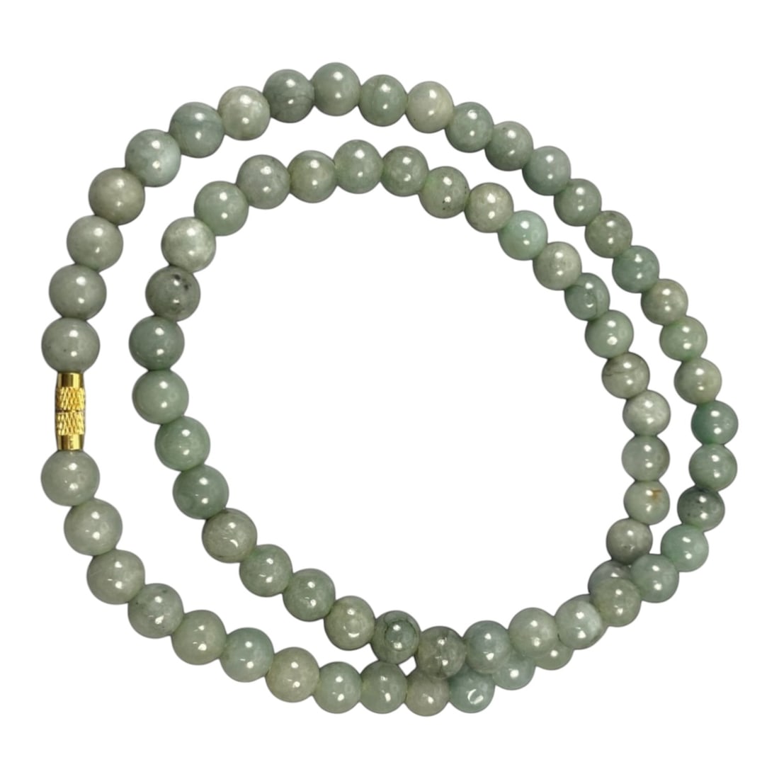 A Chinese Jadeite Jade Bead Necklace, 20th Century, 63ZK: Composed of spherical beads of uniform pale celadon green jadeite jade with subtle natural veining and minor internal inclusions, the necklace is strung in a continuous loop. The beads feature a smoot