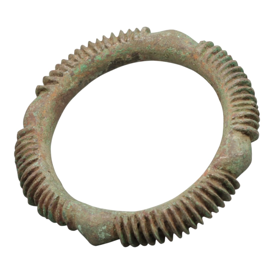 A European Bronze Ribbed Bracelet, 8th-10th Century, 95FT: Cast from bronze with a thick, rounded section, the bracelet is formed as a near-complete circle with four distinct, raised, angular nodes evenly spaced around its circumference. Between each node, th