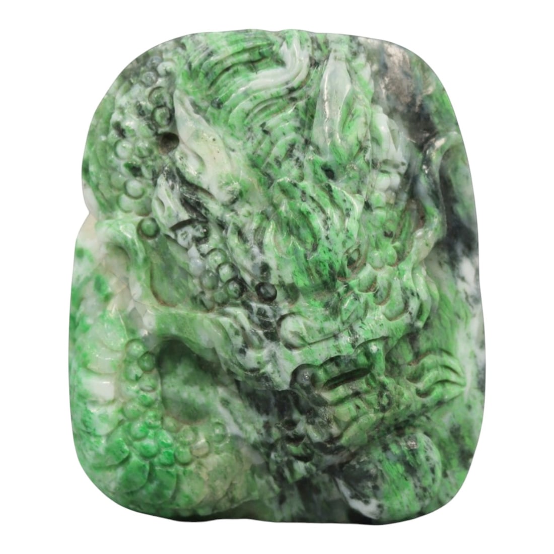 A Chinese Jadeite Jade Pendant, 20th Century, 14ZL: Carved from green jadeite jade with natural dark green and greyish inclusions distributed throughout the matrix, the pendant is formed as an irregularly rectangular object with a relief-carved dragon 