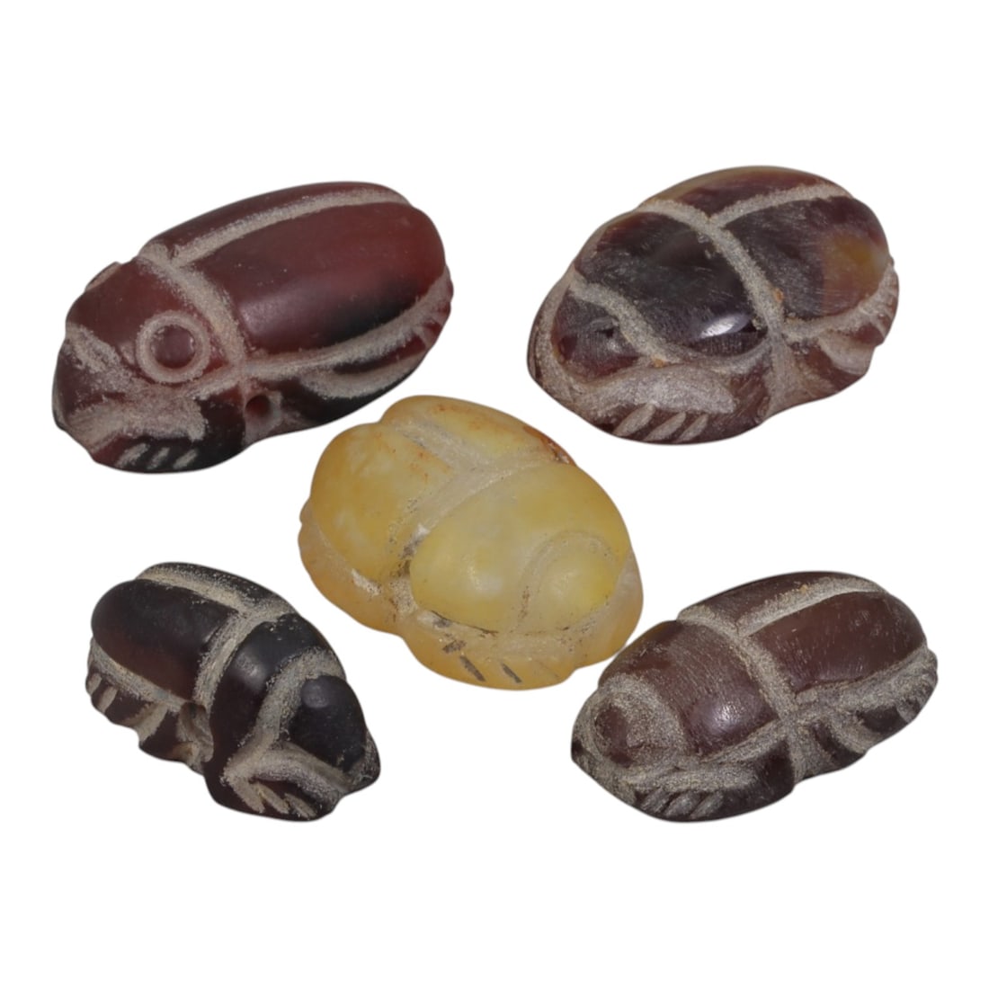 Lot of 5 Ancient Coptic Egyptian Multi-Stone Scarab Amulets, Circa Roman to Coptic Era, 83AH: Carved from semi-precious stones including carnelian/agate (reddish-brown and dark varieties) and yellowish calcite/quartz, the group consists of five distinct scarab amulets, ranging in size from 2 c