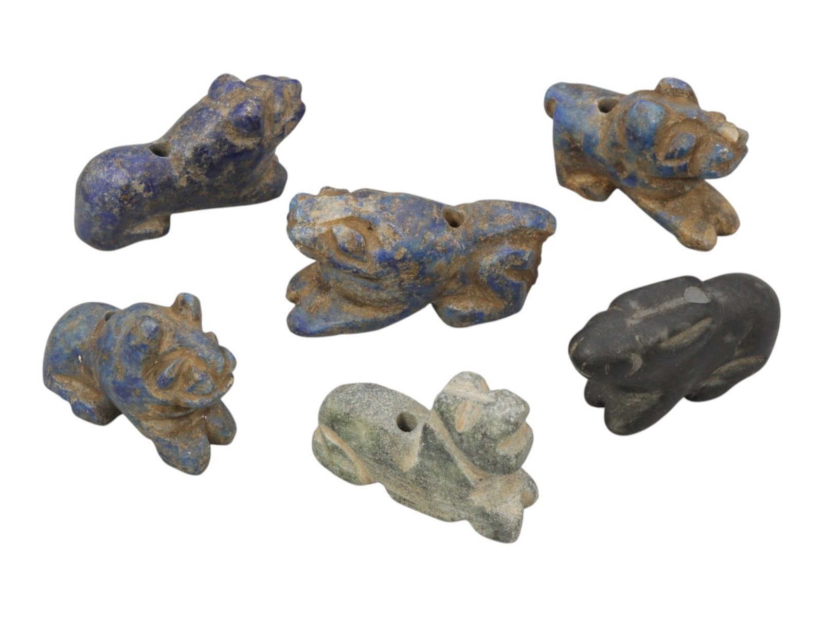 Lot of 6 Ancient Bactrian Multi-Stone Zoomorphic Amulets, 82AH: Carved from various stones including lapis lazuli (blue), green serpentine, and dark grey varieties, the group consists of six distinct zoomorphic amulets, ranging in size from 2 cm to 2.5 cm (0.79-0.