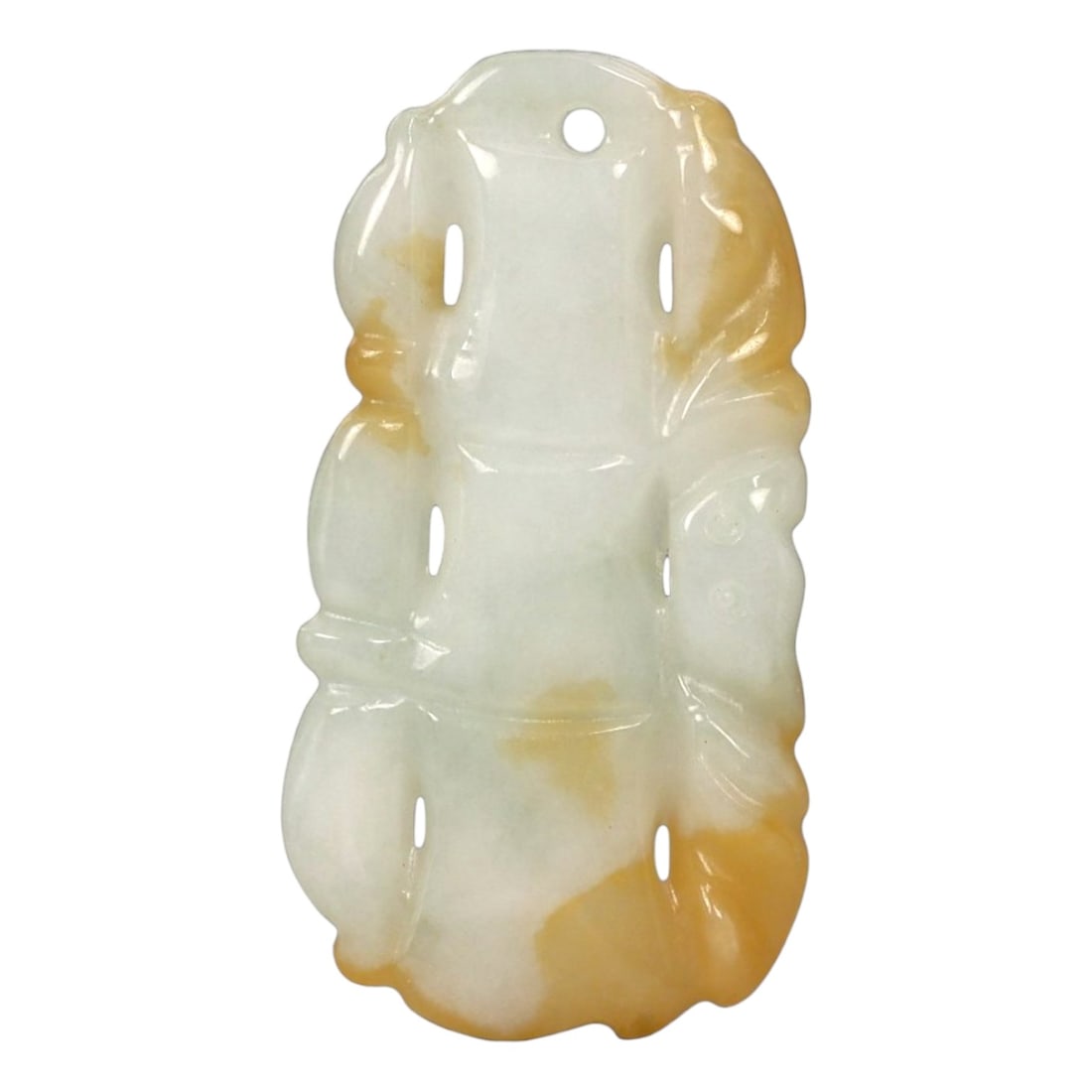 A Chinese Hetian Nephrite Jade Bamboo-Form Pendant, 20th Century, 61FA: Carved from pale white Hetian nephrite jade with natural honey-yellow russet suffusion, the pendant is worked in the form of a vertical bamboo stalk composed of segmented nodes. The carving emphasizes