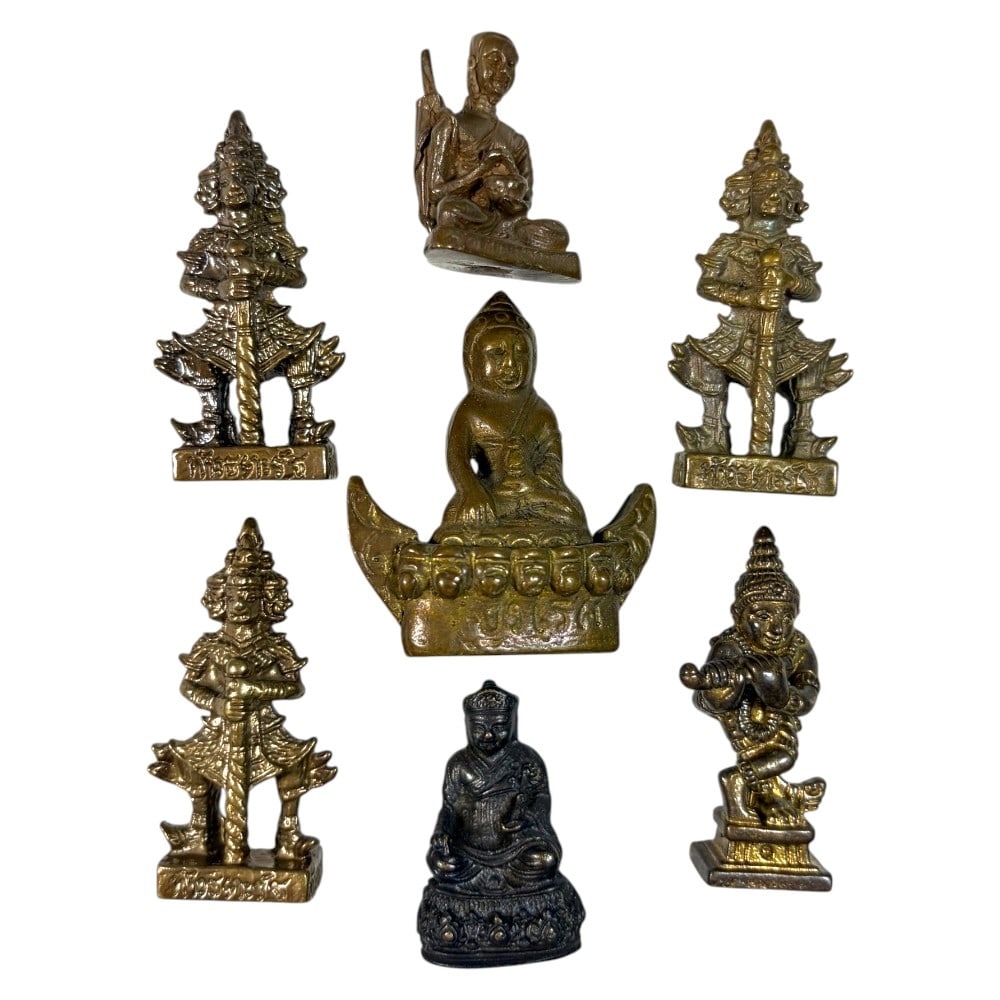 A Lot of 7 Vintage Southeast Asian Brass and Bronze Figurines, 50AA: Comprising seven small cast metal pieces ranging from 3 to 4.5 cm in height. The collection features a variety of devotional and guardian imagery, including seated Buddha and monk figures, multi-heade