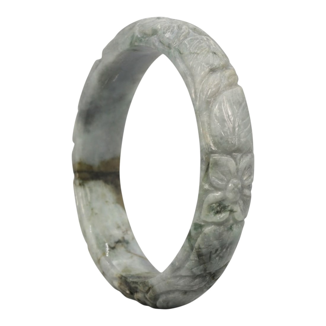 A Chinese Carved Jadeite Jade Bangle Bracelet, 20th Century, 45ZL: A fine jadeite bangle of flattened circular form, masterfully carved in relief with a continuous band of floral blossoms and scrolling foliate motifs. The stone exhibits a translucent pale greenish-gr