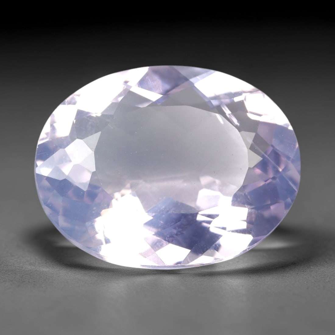 9.82 Carats Lavender Amethyst Oval - Natural Loose Gemstone, LZ60: This beautiful 9.82 carat lavender amethyst is precision-cut into a classic oval shape, measuring 17.3mm x 13.5mm x 7.1mm. It displays a soft, ethereal lavender hue, reminiscent of a misty spring morn