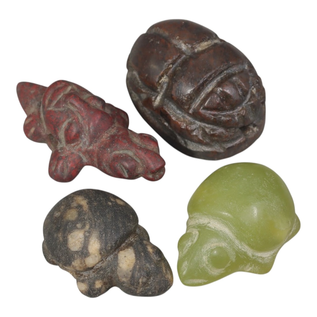 Lot of 4 Ancient Near Eastern Zoomorphic Stone Amulets, Circa 1st Millennium BCE, 64AE: Comprising four zoomorphic stone amulets of varying form and material. One red stone quadruped figure carved in low relief with stylized anatomical details. One dark brown stone scaraboid amulet with 