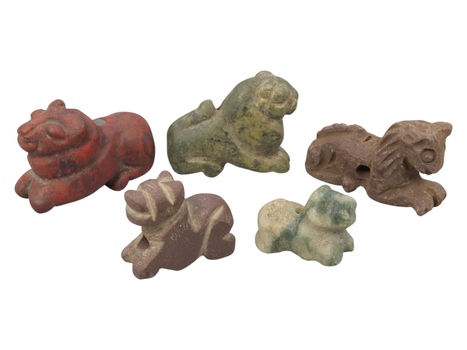 Lot of 5 Ancient Near Eastern Zoomorphic Stone Amulets, c. Iron Age to Sasanian Period, 89WK: A curated collection of five zoomorphic stone amulets from the Ancient Near East, carved from varied materials including red, green, brown, and banded stone. The set features stylized recumbent feline