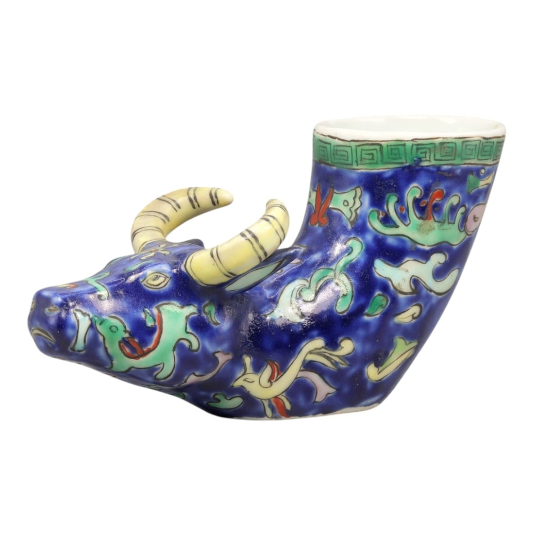 A Chinese Porcelain Bovine-Form Vessel, 20th Century, 87YC: Modeled in porcelain, the vessel is formed as a recumbent bovine with the head turned slightly to one side and the body hollowed to create an open container rising from the back. The animal is depicte