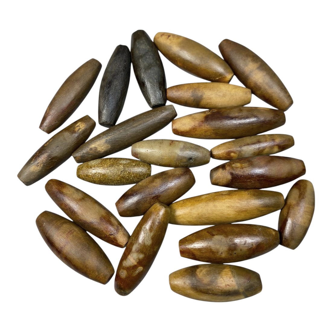 Lot of 21 Antique Himalayan Tibetan Fossilized Wood Ritual Beads, 67AG: A collection of 21 antique Himalayan Tibetan ritual beads, carved from natural fossilized wood with rich, earthy hues ranging from warm amber and golden brown to deep black. Each bead is shaped into a